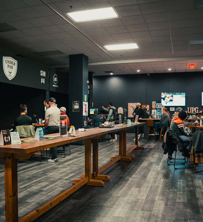 League night in the simulator bays at Under Par Golf